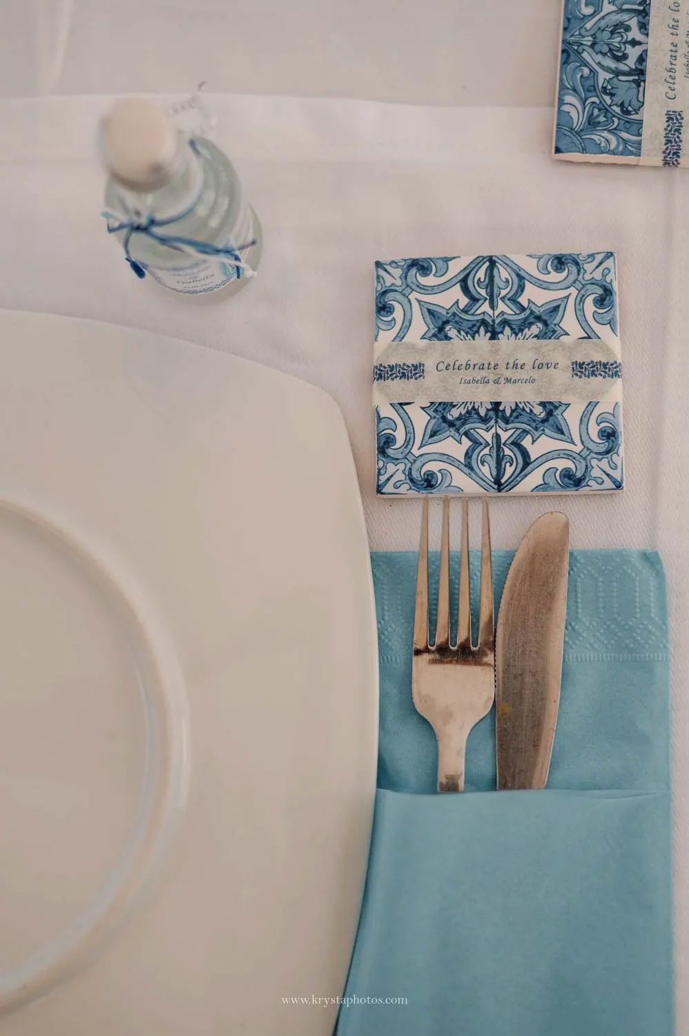 Greek island beach wedding table details with blue tile invitation
