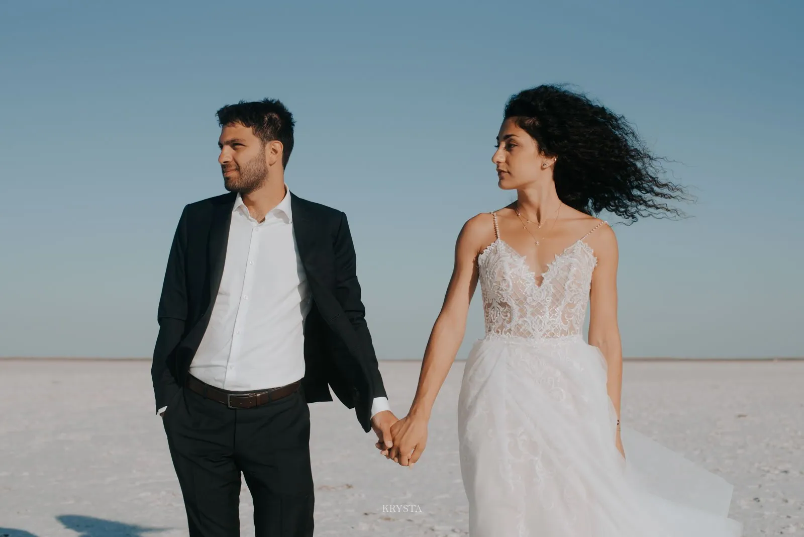 Couple on white salt flats, Greece destination wedding